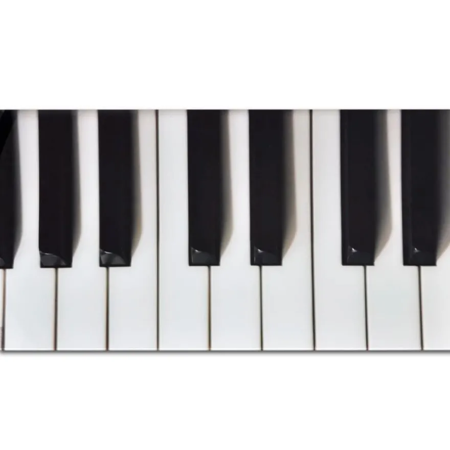 Sohvapöytä lasisella pöytälevyllä ja pianokuviolla